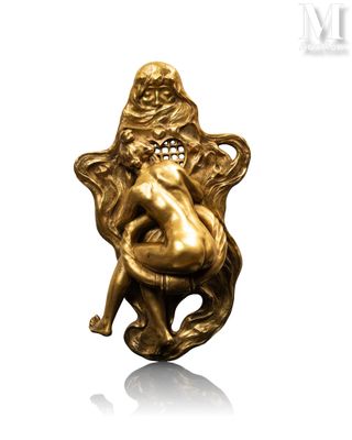 an image of a gold figurine of a woman sitting on a chair