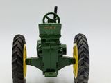 a toy tractor that is sitting on a white surface