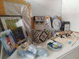 a white table with a clock, pictures, pictures, and other items on it