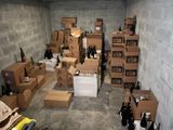 many boxes and bottles of wine in a room