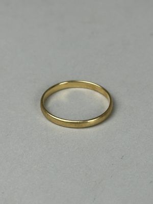 a close up of a gold ring on a white surface