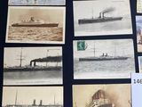 a lot of pictures of ships on display on a table