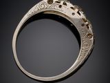 a close up of a gold ring on a black background