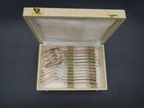 a box with a set of silverware in it on a table