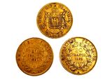three different types of gold coins sitting on top of each other