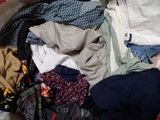 a pile of clothes that is sitting on the floor
