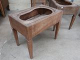 two old wooden sinks sitting on a table in a room