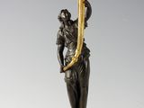 an image of a statue of a woman holding a candelabra
