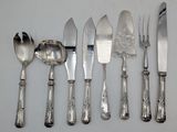 a lot of silver spoons and knives on the table
