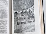 an open book with a picture of a building in it