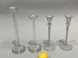 three clear glass candlesticks and a lemon on a table