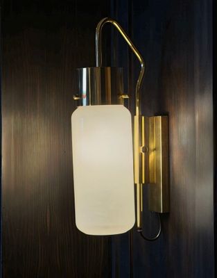 the wall light is hanging on the wall in the dark room