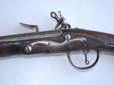 an old gun that is laying on top of a table