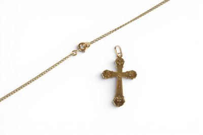 gold plated cross pendant with a chain on a white background