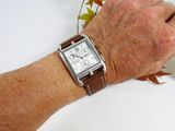 a man ' s hand with a watch on his wrist