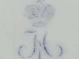 an image of a white plate with a blue flower on it