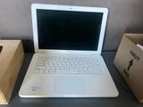 a laptop computer sitting on a table next to a box