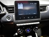 the interior of a car with a touch screen and a steering wheel