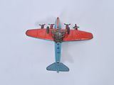 a red and blue toy airplane on a white surface