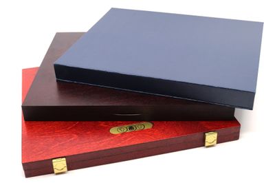 three wooden boxes are stacked on top of each other on a white surface