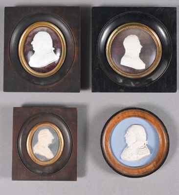 four framed portraits of men and women are displayed in wooden frames
