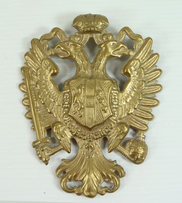 an image of a gold eagle with a crown on it ' s head