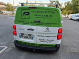 a green and white van that is parked in a parking lot