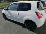 a small white car that is parked in the parking lot