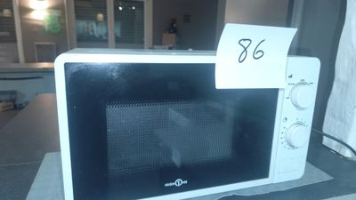 a microwave with a price tag on it sitting on a counter