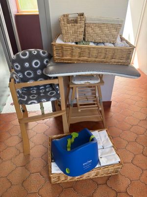 a small table with a basket on it and a chair next to it