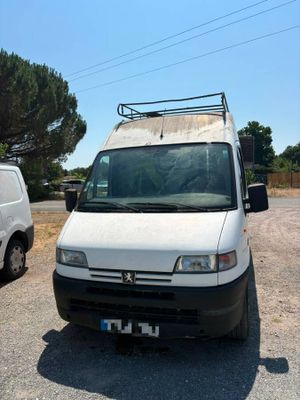 a white van parked in a parking lot next to a white van