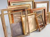 a lot of picture frames sitting on a table