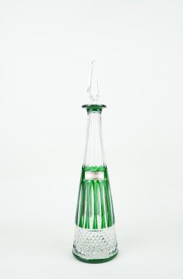 green and clear glass vase with a pointed top on a white background