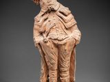 an image of a statue of a man with a hat and jacket