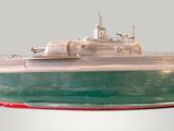 a model of a green and white boat on a table