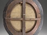 an image of a round wooden object with a cross on it