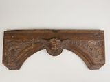 an antique carved wood shelf with a lion head on it