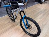 a blue and white bike on display at a bike show