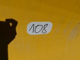 a sign that says no8 on the side of a yellow wall