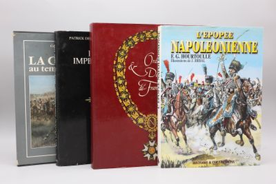 Trois livres sont posés sur une surface blanche ; l'un est rouge et l'autre est noir.