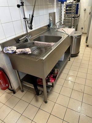 une cuisine avec un évier et une poubelle