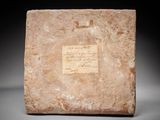 a stone block with a writing on it
