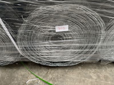 many rolls of wire wrapped in plastic on the ground