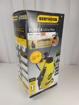 la boîte d'un compresseur électrique jaune et noir posée sur une surface blanche