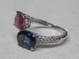 an image of a close up of a ring with two different colored stones
