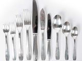 a lot of silver spoons and forks on the table