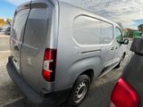 a silver van that is parked in a parking lot