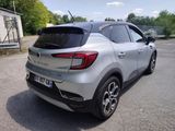 the rear end of a silver car parked in a parking lot