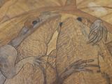 a close up of a wooden table with a painting on it