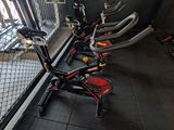 many bikes that are lined up in a room